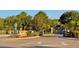 A view of the community entrance with mature trees at 1147 Halapa Way, Trinity, FL 34655