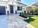 Stunning front entrance with beautiful brick columns, paver walkway and well-maintained landscaping at 1147 Halapa Way, Trinity, FL 34655
