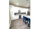 This kitchen showcases white cabinets, a wine cooler, and marble countertops at 1147 Halapa Way, Trinity, FL 34655