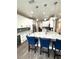 Bright kitchen features white cabinets, marble countertops and an island with seating at 1147 Halapa Way, Trinity, FL 34655