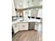Spacious kitchen featuring stainless appliances, white cabinetry, and island seating at 1147 Halapa Way, Trinity, FL 34655
