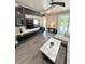 This bright living room has an open floor plan with a sliding glass door and modern decor at 1147 Halapa Way, Trinity, FL 34655