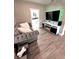 Comfortable living room featuring a plush sofa, media center, and stylish design at 1147 Halapa Way, Trinity, FL 34655