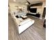 Bright living room features hardwood floors and a large white comfortable sectional at 1147 Halapa Way, Trinity, FL 34655