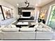Comfortable living room offers stylish furniture, hardwood floors and a ceiling fan at 1147 Halapa Way, Trinity, FL 34655