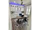 Bright, modern office with white cabinets, grey accent wall, and hardwood floors at 1147 Halapa Way, Trinity, FL 34655