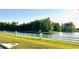 Scenic pond view featuring a white fence and lush green landscaping, creating a peaceful atmosphere at 1147 Halapa Way, Trinity, FL 34655