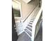 Elegant staircase design featuring wood treads, white risers, and modern wainscoting at 1147 Halapa Way, Trinity, FL 34655