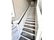 Stylish staircase with wood treads, a dark handrail, and modern wainscoting at 1147 Halapa Way, Trinity, FL 34655
