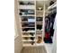Stylish walk-in closet with shelves for shoes, handbags, and hanging clothes at 1147 Halapa Way, Trinity, FL 34655