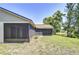 Expansive backyard with screened enclosure, lush lawn, and picturesque pond view, creating a private oasis at 12846 Tallowood Dr, Riverview, FL 33569