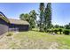 Spacious backyard with a pond view, mature trees, screen porch and a sunny lawn area at 12846 Tallowood Dr, Riverview, FL 33569