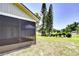 Scenic backyard featuring a screened-in patio, green lawn, and a tranquil pond, offering a peaceful retreat at 12846 Tallowood Dr, Riverview, FL 33569