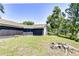 Lush backyard with a screened enclosure, mature trees, and pond access, providing a serene and private outdoor space at 12846 Tallowood Dr, Riverview, FL 33569