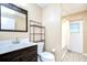 Well-lit bathroom with modern vanity, stylish mirror, and convenient storage shelves for an organized space at 12846 Tallowood Dr, Riverview, FL 33569