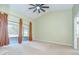 Bright bedroom with a ceiling fan, sliding glass door, and access to an outdoor patio at 12846 Tallowood Dr, Riverview, FL 33569