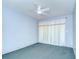 Light-filled bedroom with soft carpet and a ceiling fan, offering a serene atmosphere and comfortable living at 12846 Tallowood Dr, Riverview, FL 33569