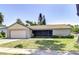 Charming single-story home with a well-manicured lawn, attached garage, and a screened porch, offering curb appeal at 12846 Tallowood Dr, Riverview, FL 33569
