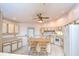 Bright kitchen featuring white appliances, tiled flooring, bar seating, and a ceiling fan at 12846 Tallowood Dr, Riverview, FL 33569