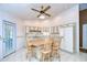 Bright kitchen featuring white cabinets, tiled flooring, a kitchen island with bar seating, and a ceiling fan at 12846 Tallowood Dr, Riverview, FL 33569