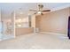 Open-concept living room, seamlessly connected to the kitchen, features bright neutral walls and a ceiling fan at 12846 Tallowood Dr, Riverview, FL 33569