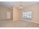 Cozy living area featuring carpet flooring, neutral walls, and abundant natural light at 12846 Tallowood Dr, Riverview, FL 33569