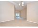 Spacious living room with sliding glass doors leading to an enclosed porch and carpet flooring at 12846 Tallowood Dr, Riverview, FL 33569