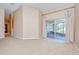 Expansive living area features sliding glass doors to the lanai, neutral paint and carpet floors at 12846 Tallowood Dr, Riverview, FL 33569