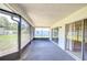 Spacious screened patio with serene views of the surrounding yard and neighborhood, ideal for outdoor living at 12846 Tallowood Dr, Riverview, FL 33569
