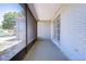 Inviting screened porch with white painted walls and a view of the neighborhood at 12846 Tallowood Dr, Riverview, FL 33569