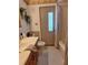 The bathroom has a neutral color scheme, decorative art, and a shower with tub combo at 1291 Stony Brook Ln, Dunedin, FL 34698