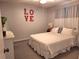 This bedroom features soft carpet, cute wall decorations, a comfy bed, and calm curtains at 1291 Stony Brook Ln, Dunedin, FL 34698