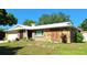 Charming single-story home featuring stone accents and a well-maintained front yard at 1291 Stony Brook Ln, Dunedin, FL 34698