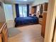 Comfortable bedroom with wood-look floors and access to a private patio at 1291 Stony Brook Ln, Dunedin, FL 34698