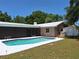 Relax in this backyard with a screened in patio, in ground pool and shed for storage at 1291 Stony Brook Ln, Dunedin, FL 34698