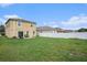 Expansive backyard with a patio, lush green grass, and a privacy fence at 13246 Kent Bradley St, Dade City, FL 33525