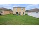 Spacious backyard with green grass and a concrete patio, perfect for outdoor activities at 13246 Kent Bradley St, Dade City, FL 33525
