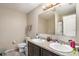 Well-lit bathroom with double sinks, granite counters, and updated fixtures at 13246 Kent Bradley St, Dade City, FL 33525