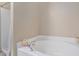 Bright white bathtub with a shower next to it at 13246 Kent Bradley St, Dade City, FL 33525