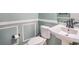 Cozy half-bathroom with decorative molding and pedestal sink at 13246 Kent Bradley St, Dade City, FL 33525