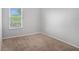The empty bedroom space with carpet offers a blank slate with natural light perfect for personalization and decor at 13246 Kent Bradley St, Dade City, FL 33525