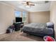 Comfortable bedroom features carpet, a ceiling fan, and natural light from the window at 13246 Kent Bradley St, Dade City, FL 33525