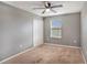 This bedroom features neutral walls, a ceiling fan, and a window for natural light creating a calm atmosphere at 13246 Kent Bradley St, Dade City, FL 33525