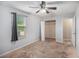 The bedroom features a window, ceiling fan, closet, and carpeted floors for a comfortable and inviting space at 13246 Kent Bradley St, Dade City, FL 33525