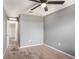 This neutral bedroom provides a blank slate with a ceiling fan and a door leading to an adjacent room at 13246 Kent Bradley St, Dade City, FL 33525