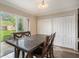 Bright dining area with a slider to the back yard, a table, and closet space for storage at 13246 Kent Bradley St, Dade City, FL 33525