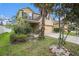 Charming two-story home featuring an attached two-car garage, complemented by lush landscaping at 13246 Kent Bradley St, Dade City, FL 33525