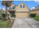 Charming two-story home with a well-manicured lawn and a two-car garage, showcasing its inviting curb appeal at 13246 Kent Bradley St, Dade City, FL 33525