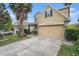 Charming two-story home featuring an attached two-car garage, complemented by lush landscaping at 13246 Kent Bradley St, Dade City, FL 33525