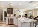 A spacious kitchen with stainless steel appliances and a granite island provides an open and inclusive space at 13246 Kent Bradley St, Dade City, FL 33525